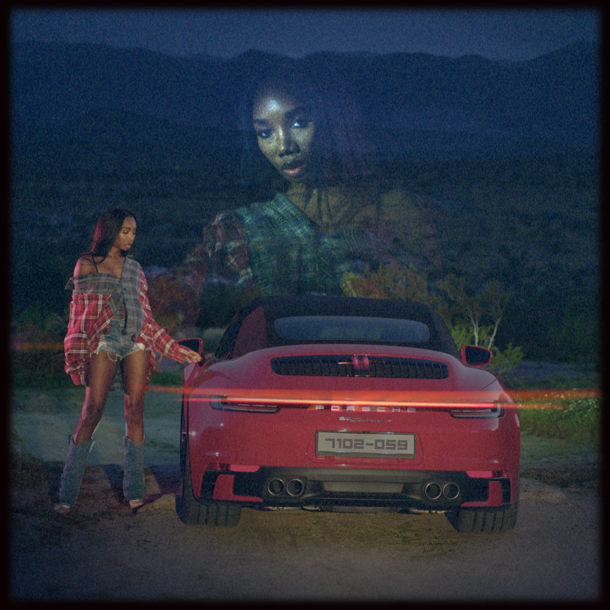 Amira beside a red Porsche at dusk, her portrait double-exposed into the mountains